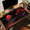 A large silicone gaming mouse pad featuring a dark background with a red moon and red foliage.