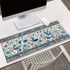 A vintage Persian rug design mouse pad with a non-slip rubber base placed on a white desk.