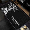 A black mouse pad featuring a white silhouette of a dragon and the Death Note logo on a wooden desk surface.