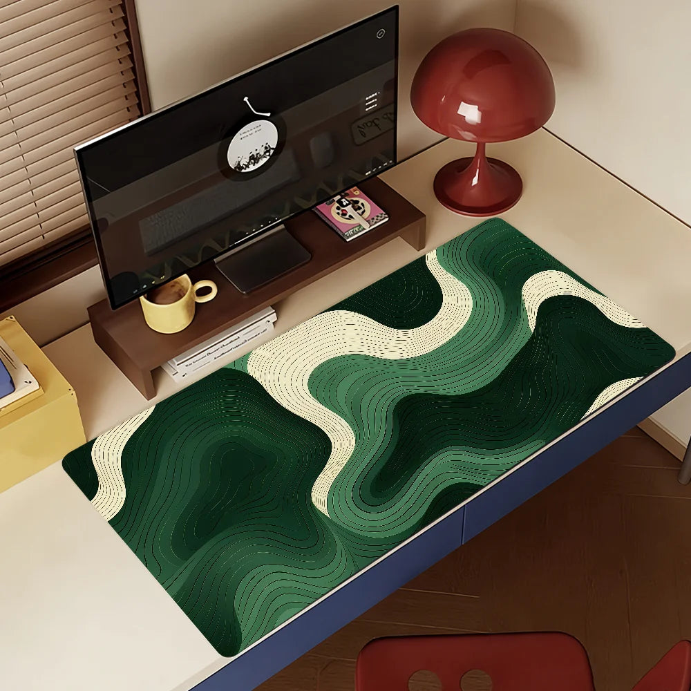 A dark green mouse pad with white abstract wavy patterns is placed on a wooden desk.