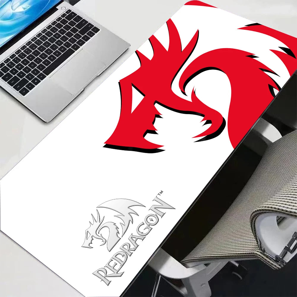 A red and black anime gaming mouse pad with an anti-slip rubber base is shown next to a laptop.
