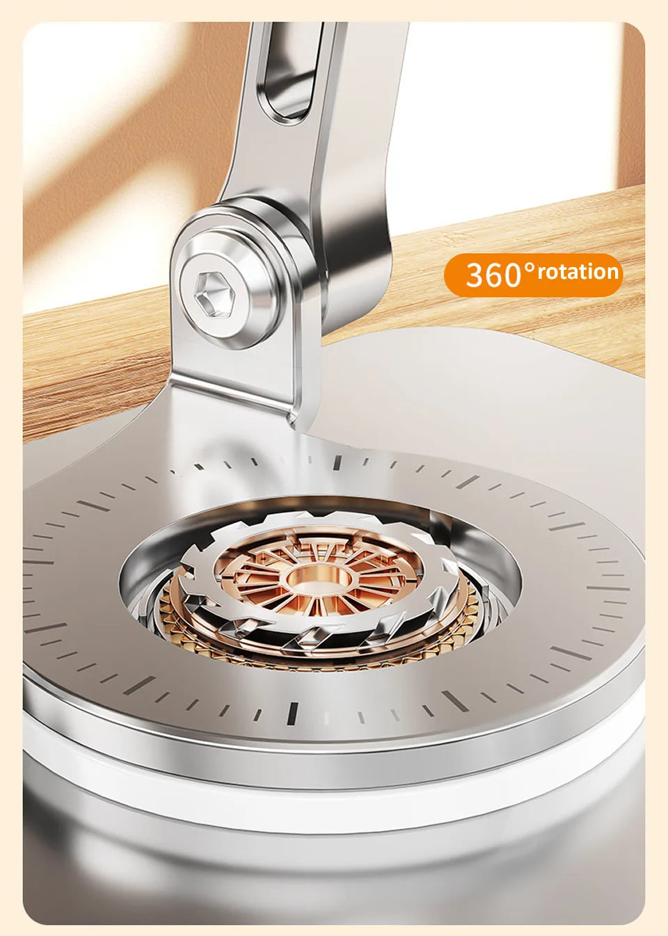 A close-up view of a silver 360° rotating tablet stand mechanism with a rotating base and a metal clamp.