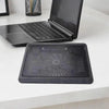A black laptop is placed on an adjustable metal cooling pad with an integrated LED fan.