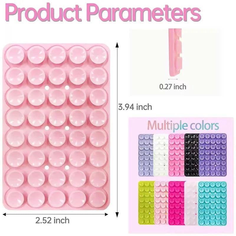 A pink silicone suction cup phone mount with multiple color options shown in a storage tray.