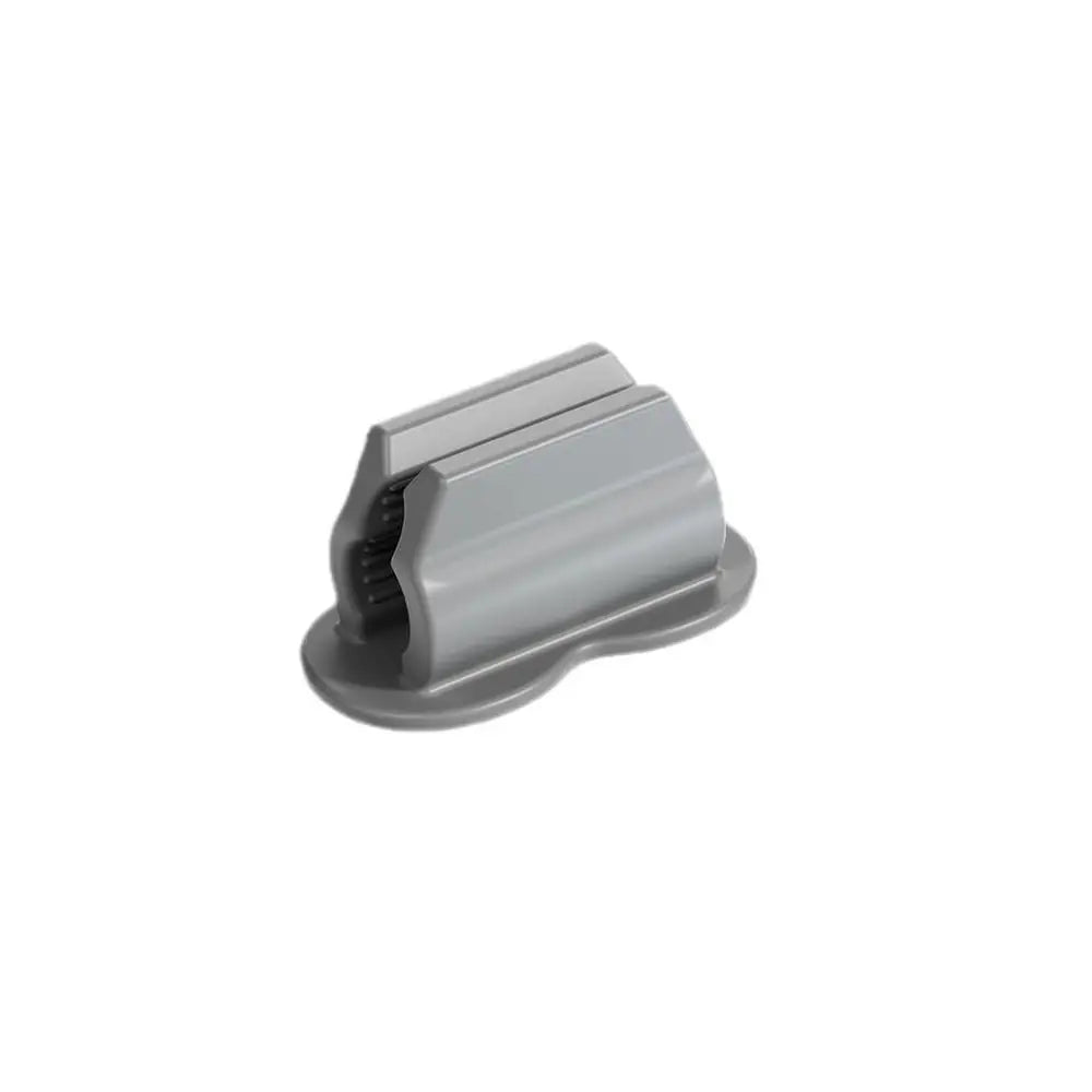 A gray silicone self-adhesive pen holder with a tapered design.
