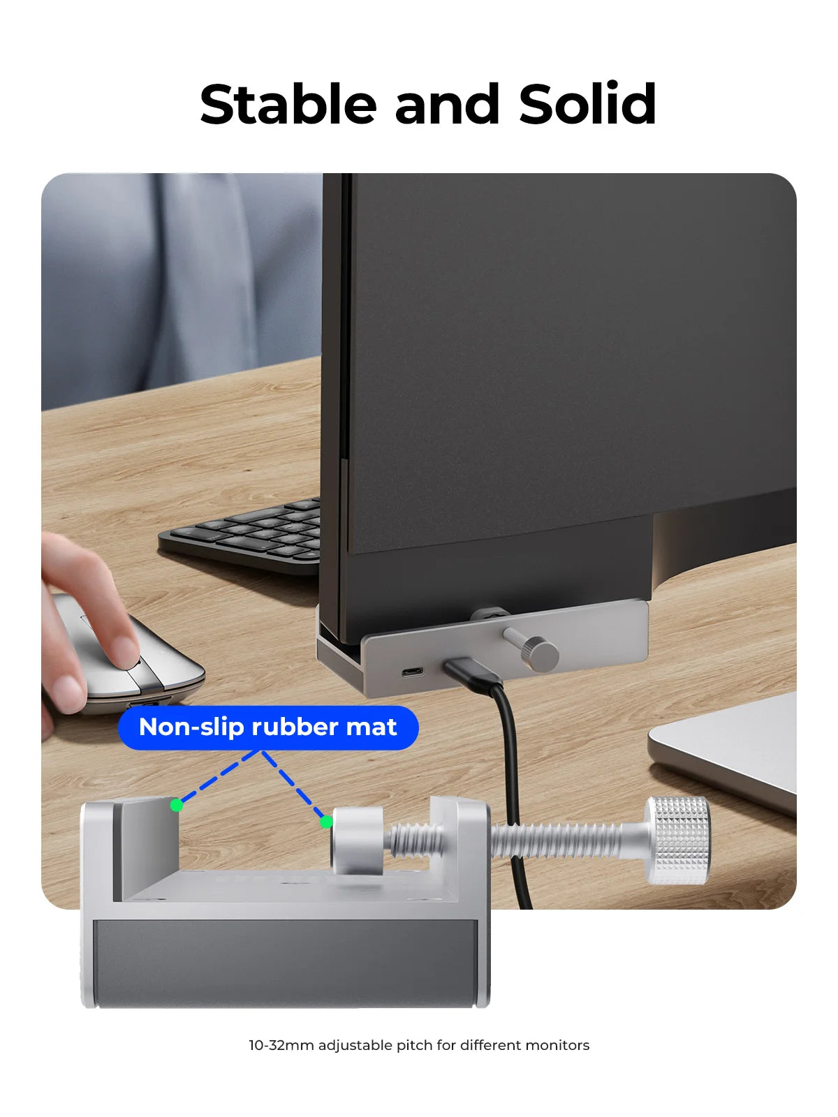 A silver adjustable adapter for monitors, showing its fit and stability on a wooden desk.