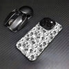 A black matte shockproof case for an iPhone is shown next to the phone and a wireless earbud.