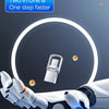 A close-up of a white portable device with a metal body is shown being held by a robotic hand against a glowing circular back