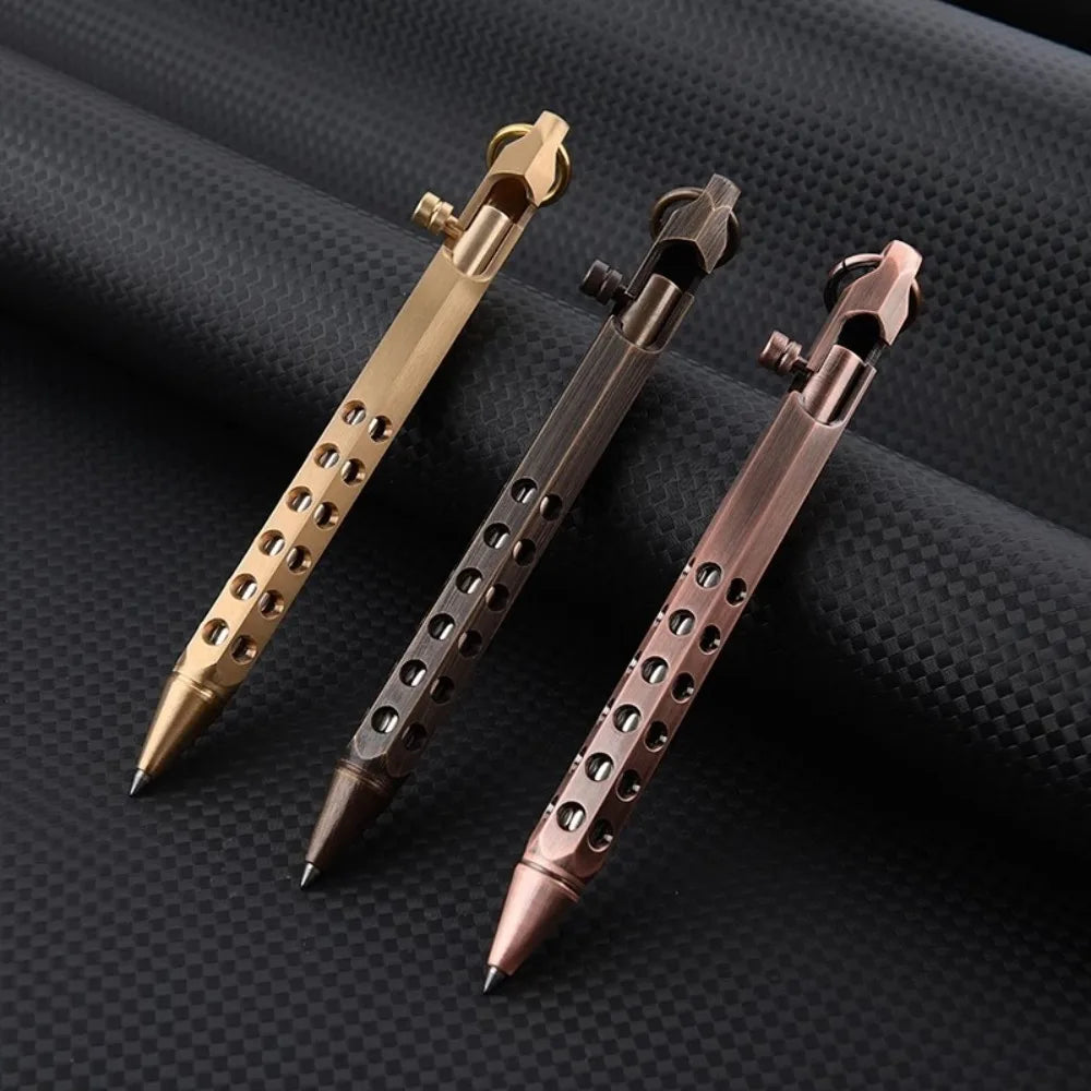 Three brass bolt-action ballpoint pens of varying finishes are displayed on a dark surface.