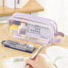 A purple transparent large-capacity pencil case is shown open with various school supplies inside on a wooden surface.