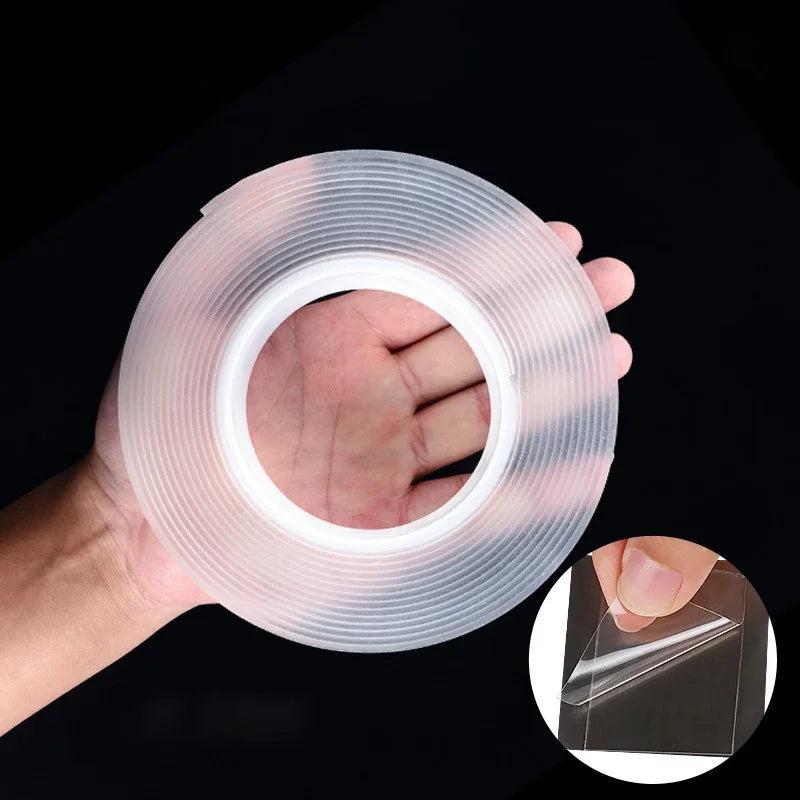 A hand holds a roll of clear double-sided gap tape, showing the transparent plastic material.