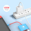 A close-up of a blue gaming device connected to a white power adapter and a blue USB-C hub for fast charging.