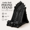 A black gothic skull phone stand with intricate carvings and a decorative arched design.