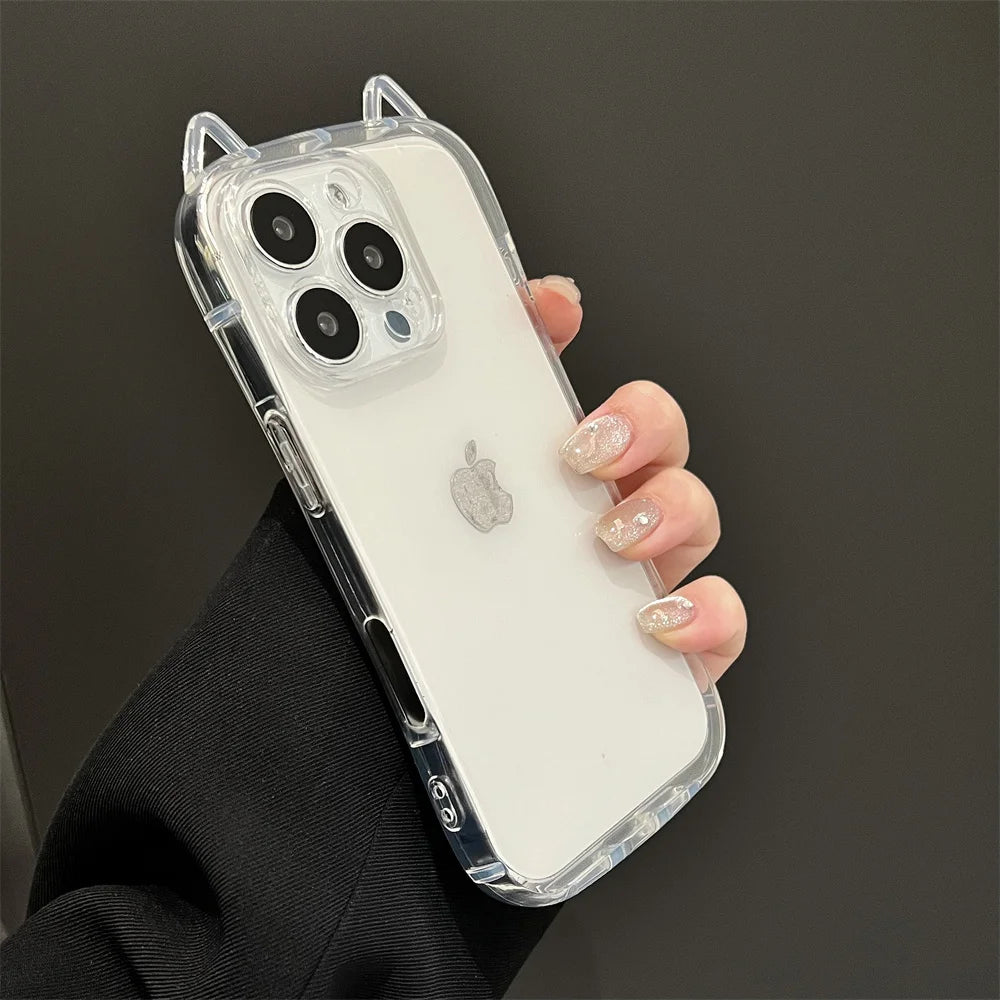 A hand holds a clear silicone case with cat ears on an iPhone, featuring shockproof protection.