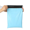 A hand is holding a light blue reusable waterproof poly shipping bag with a black seal.