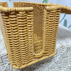 Handwoven rattan cable management box with a lid in natural tan color