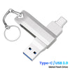 A silver metal flash drive with a keyring attached, featuring a USB-C connector.
