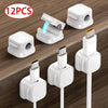 Twelve magnetic cable clips in white and black are shown for desk organization.