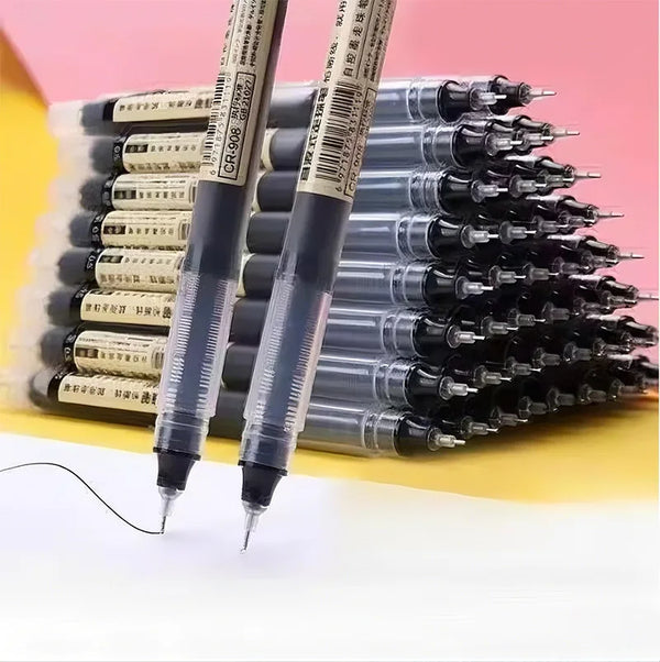 A close-up view of a stack of black and silver fine point pens with gold accents on a pink background.