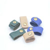 A collection of ten faux leather data cable earphones in various shades of blue and beige.