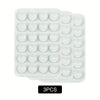 A pack of three white silicone suction phone mounts in a plastic tray.