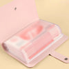 A pink reusable envelope money saving challenge binder with a clear plastic sleeve inside.