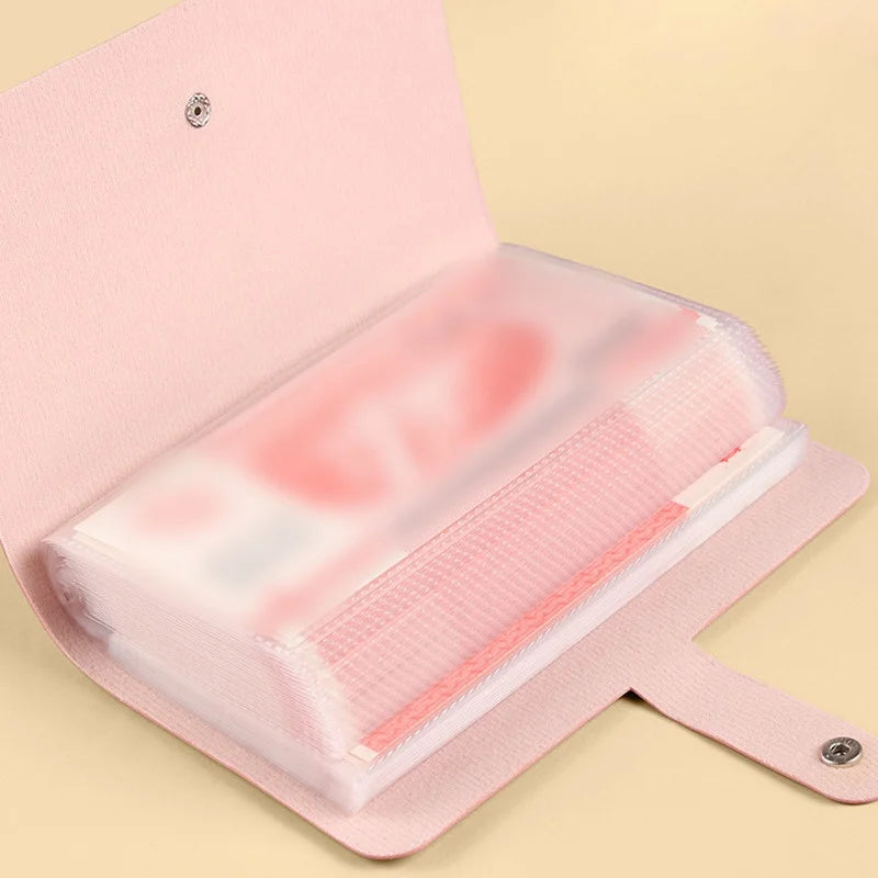 A pink reusable envelope money saving challenge binder with a clear plastic sleeve inside.