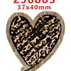 A heart-shaped acrylic hairbow with a leopard print design and the number 258883 printed on it.