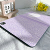 A purple composition book cover with a pencil holder resting on a white sheet.