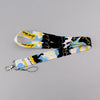 A yellow and white cat-themed lanyard with a card holder attached to a key ring.