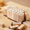 A collection of vintage wooden stamp seals arranged in a row, featuring letters and punctuation marks.