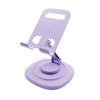 A purple foldable desktop phone stand with a rotating base and a clip for holding a phone.