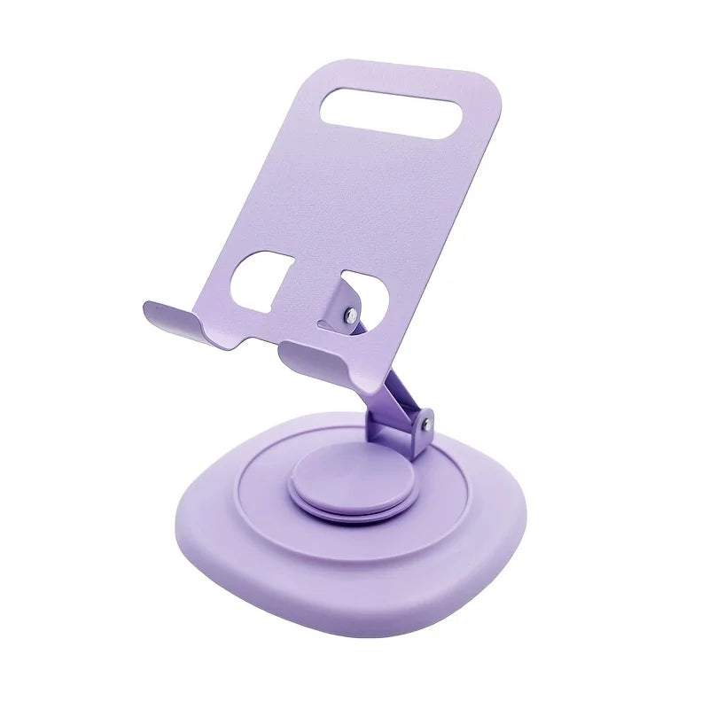 A purple foldable desktop phone stand with a rotating base and a clip for holding a phone.