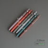 A collection of precision gel pens in various shades of pink, red, and blue, shown diagonally on a gray surface.