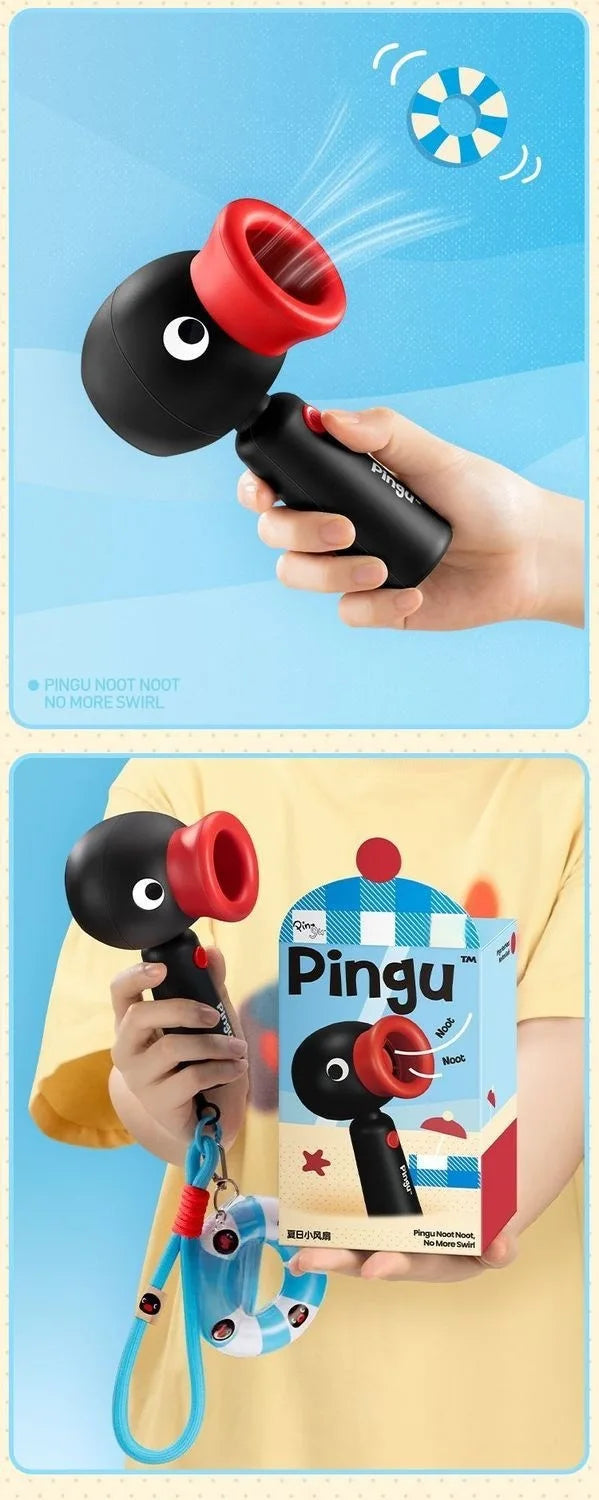 A hand holds a black and red Pingu penguin handheld fan with a rotating head against a light blue background.