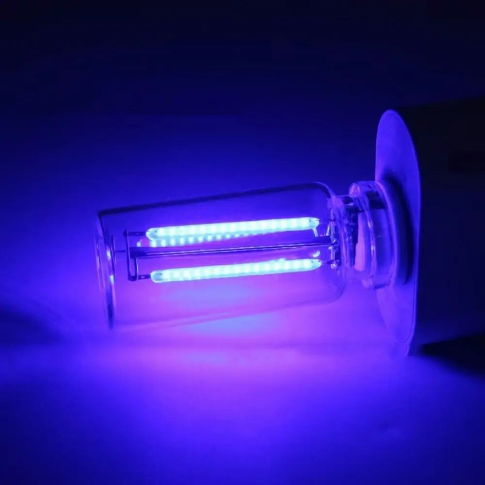 A glowing retro Edison style LED bulb with a clear glass envelope is illuminated in purple light.