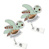 A charm featuring a cute green and brown turtle with sparkly wings and the text 'NURSE' on a silver badge reel.