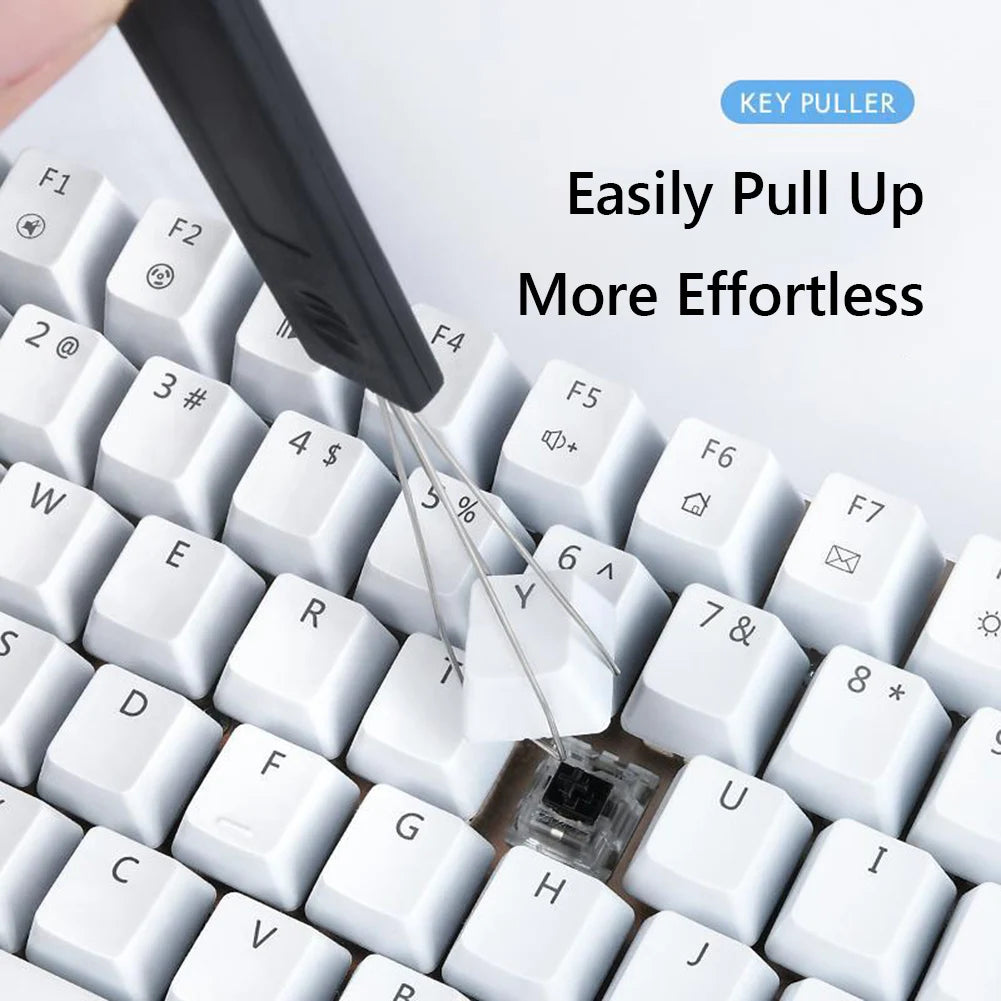 A black mechanical keyboard keycap puller is shown above a white keyboard, demonstrating how to easily pull up keycaps.