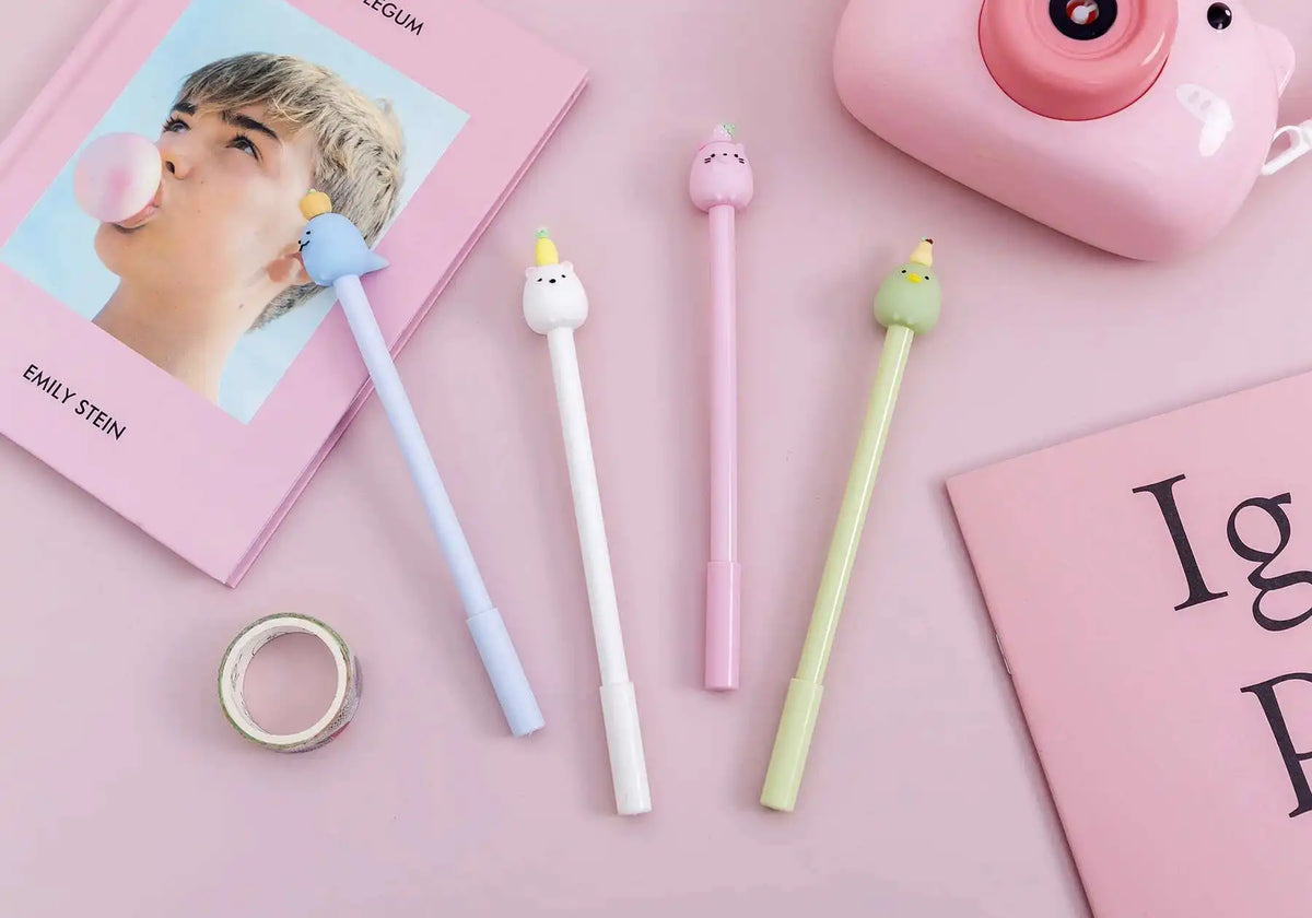 A collection of cute cartoon fruit gel pens in various pastel colors and shapes arranged on a pink background.