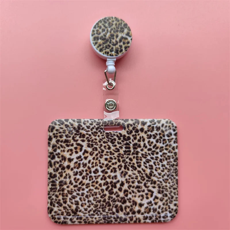 A leopard print retractable card holder clip with a round cap and a rectangular holder.