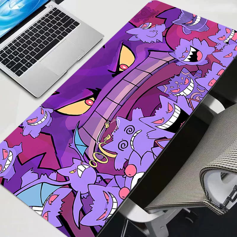 A vibrant purple and pink print XXL Gengar gaming mouse pad featuring a stylized monster design on a desk mat.