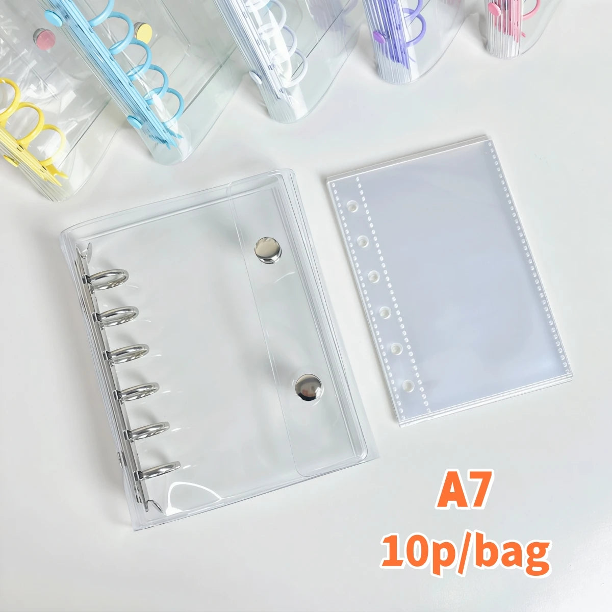A clear A7 binder with a plastic cover and a white sheet, shown next to colorful binder clips.