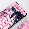 A close-up view of pink and dark purple Raven Sakura theme PBT mechanical keycaps arranged on a black keyboard tray.