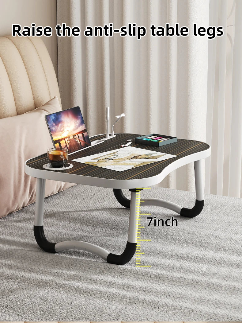 A laptop desk organizer tray with anti-slip table legs is shown on a light gray carpet.