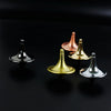 A collection of metal hand spinning tops in various colors including silver, gold, and rose gold displayed on a dark surface.