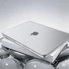 A silver Apple laptop is shown inside a white protective case, resting on a reflective surface.