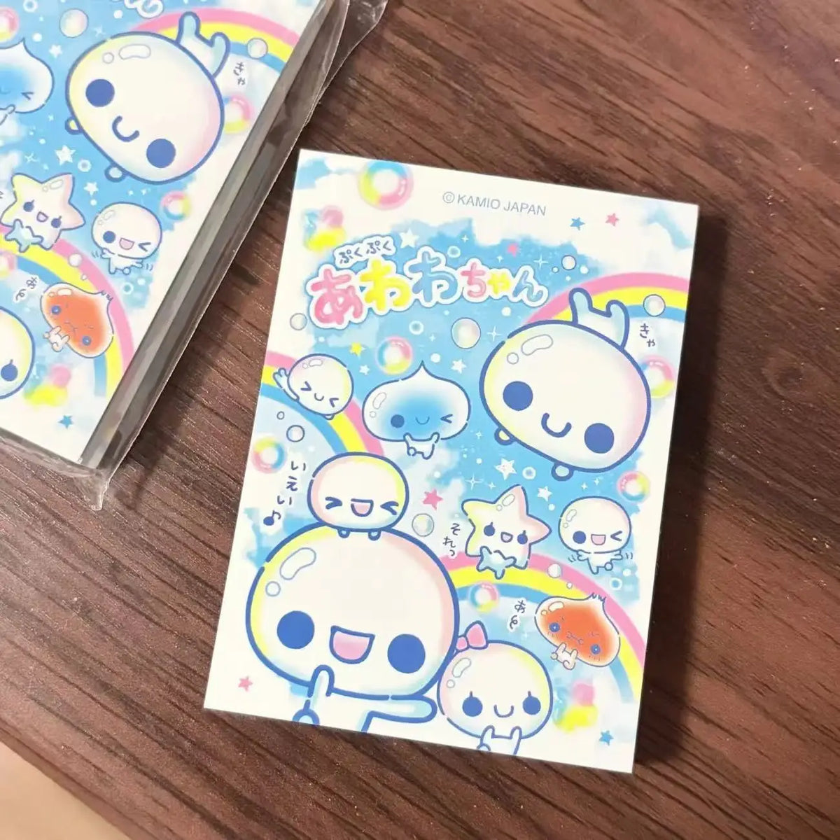 A pack of decorative memo pads featuring cute, round character illustrations in retro style.