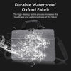 A black Oxford fabric laptop tote bag is shown with water splashing around it.
