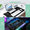 A large mouse pad is shown with a laptop, mouse, and keyboard on a desk surface for gaming and working.