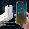 A hand holds a smartphone displaying an 85% battery charge, connected to a white charging adapter and cable.